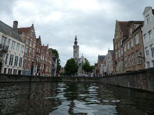Canal, Bruges and Jan van Eyck Square and monument in distance.