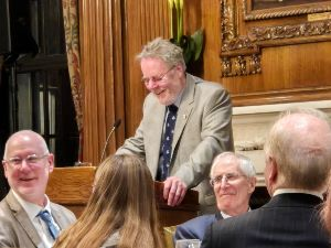 2025 Council Chair, Norman Train, shares an after dinner joke with members and guests.