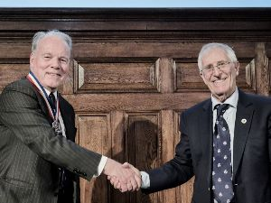 The incoming 2025 President, Roger Venables (left) receives congratulations from the outgoing 2024 President, Chris Foster (right).