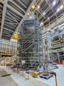 ITER Tokamak Assembly Building. Assembling the central solenoid comprising six modules with a total weight of 1,000 tonnes. The central solenoid is a superconducting electromagnet at the core of the Tokamak Reactor that acts like a transformer's primary coil inducing a large electric current in the plasma to initiate and maintain the fusion reaction.