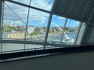 Gateshead Millennium Bridge viewed from the Glasshouse. Known as the 'Blinking Eye Bridge' designed by Wilkinson and Eyre Architects and Consulting Engineers Gifford and Partners. First ever tilting bridge comprising two arches which counterbalance each other as the bridge tilts.