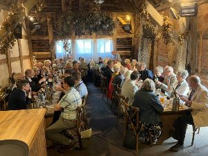 Members and Partners enjoy dinner in the mediaeval thatched barn at the Fleece Inn, Bretforton, Evesham, Worcestershire (Owned by the National Trust).