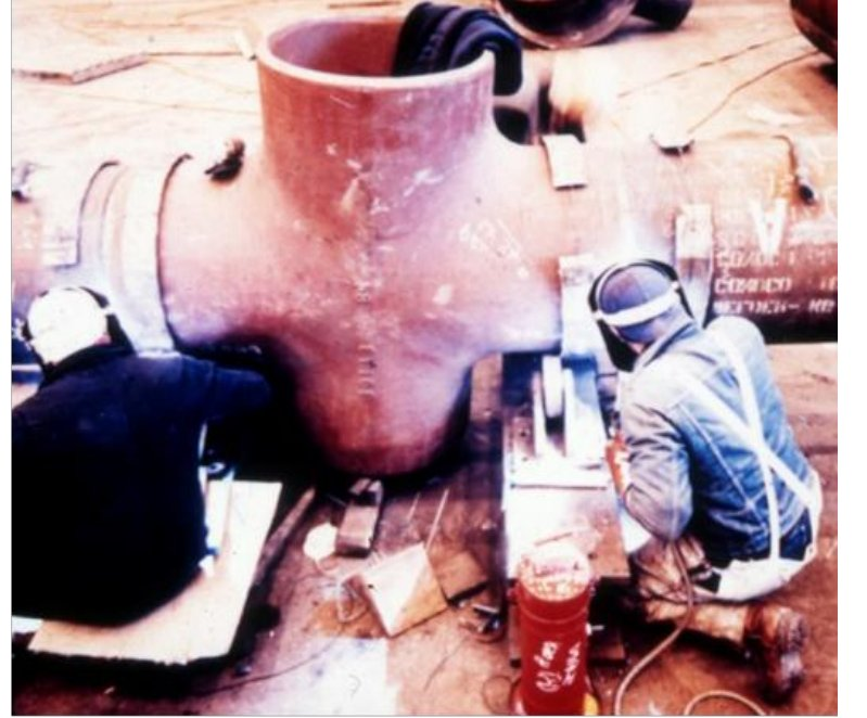 Workers in protective gear finishing a large cast steel node for an offshore platform