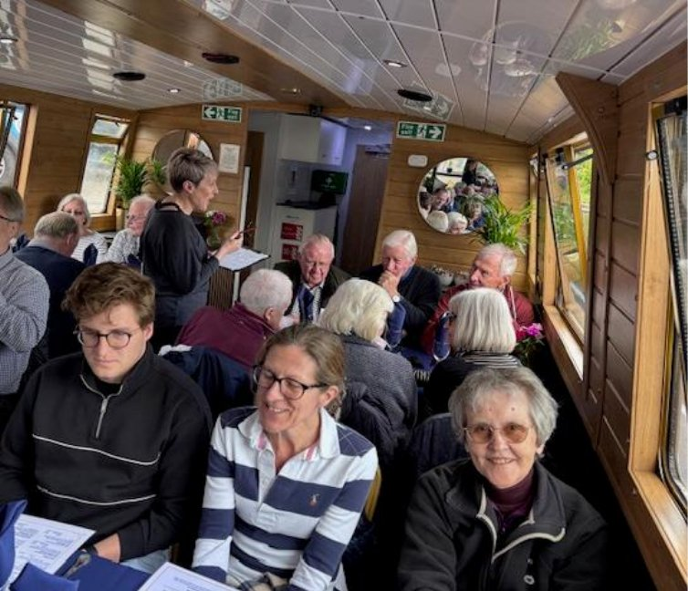 IESF members seated in the saloon of the Countess of Bridgewater narrowboat while lunch orders are taken
