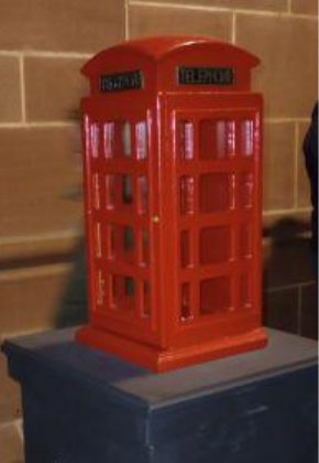 Model of a red K2 telephone box on a plinth in Liverpool Cathedral