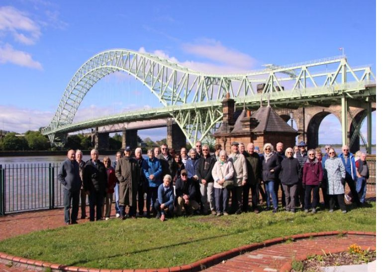 Group photo of the IESF voyagers in front of the green steel arch of the Silver Jubilee Bridge, Widnes